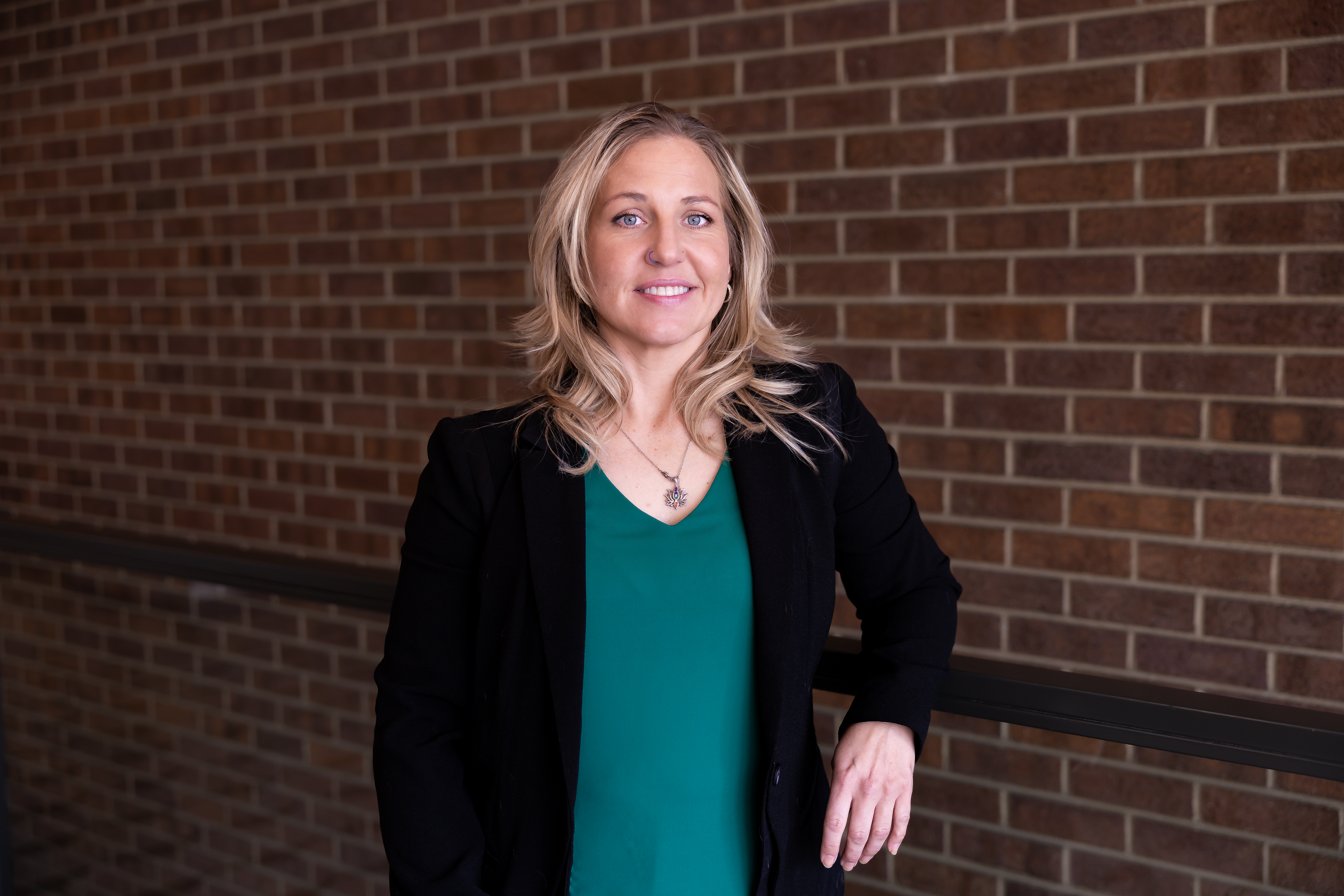 Picture of social worker in green top with black blazer